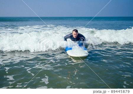 surf instructor showing how riding on big waves in Goa India surf instructor showing how riding on big waves in Goa India 89445879
