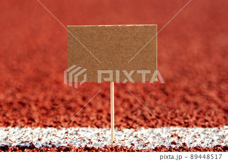 Blank mini paper pointer on a red running track Blank mini paper pointer on a red running track 89448517