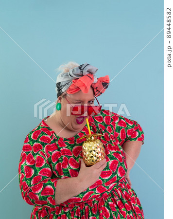 Overweight plus size female, fat women, Fat girl, Chubby, holding golden fruit ananas isolated on cyan background - lifestyle Woman diet weight loss overweight problem concept.  89448582