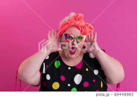 Happy Plus Size Woman Wearing Eyeglasses Smiling To Camera Standing Over Pink Background. Cheerful Millennial Female In Eyewear Posing In Studio. 89448965