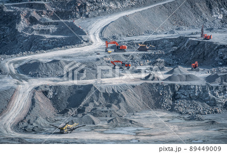 Excavators and drill rigs work in stone quarry 89449009