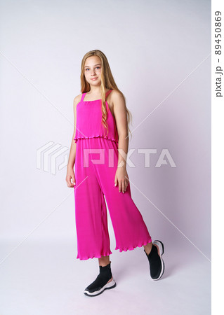 Beautiful teen girl posing in pink on a white background 89450869