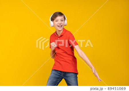Portrait funny handsome caucasian guy in red t-shirt, listening to music Portrait funny handsome caucasian guy in red t-shirt, listening to music 89451069