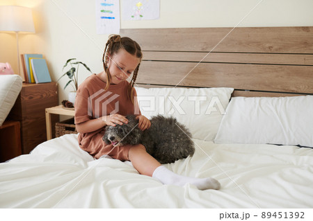 Smiling Girl Patting Dog Smiling Girl Patting Dog 89451392