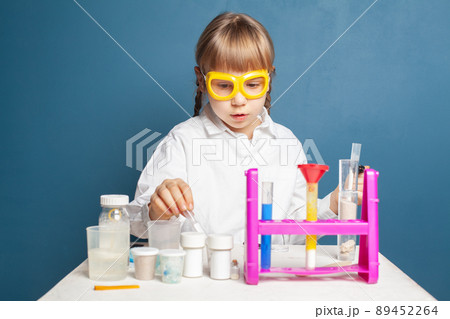 Smart student child girl with flasks in school laboratory Smart student child girl with flasks in school laboratory 89452264