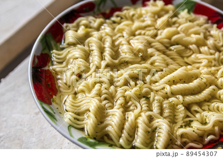 Plate full with spaghetti. Food background 89454307