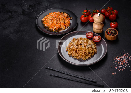 Thai noodle and chicken plate on a black concrete background with Chinese chopsticks and copy space 89456208