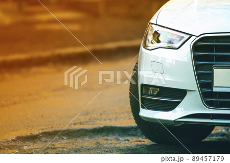 Close-up view of a new modern car parked on the side of the street. Soft ligtht effect. Close-up view of a new modern car parked on the side of the street. Soft ligtht effect. 89457179