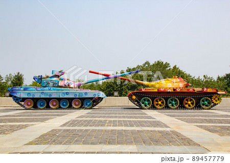 Tanks are painted in bright colors. Military Vehicles are painted with flower patterns. Tanks with crossed barrels. Anti-war concept. War and Peace. Russian invasion of Ukraine 89457779