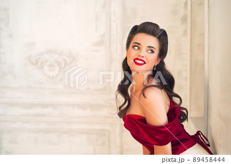 Pretty coquettish pin-up girl in retro interior Pretty coquettish pin-up girl in retro interior 89458444