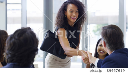 Glad to finally meet you. Cropped shot of a businesswoman shaking hands with colleagues during a meeting in a modern office. 89467619