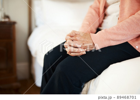 What am I waiting for. Cropped shot of a senior woman sitting on the edge of a bed in a nursing home. 89468701