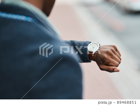 Never underestimate the value of time. Cropped shot of a businessman checking the time against an urban background. Never underestimate the value of time. Cropped shot of a businessman checking the time against an urban background. 89468851