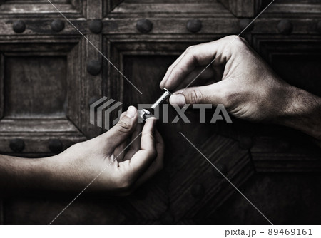 Doing a little DIY. Two hands screwing together a nut and bolt. 89469161