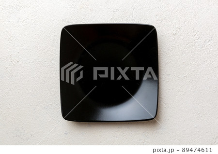 Top view of empty square plate on cement background. Empty space for your design 89474611