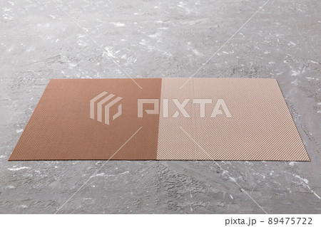 Perspective view of brown tablecloth for food on cement background. Empty space for your design 89475722