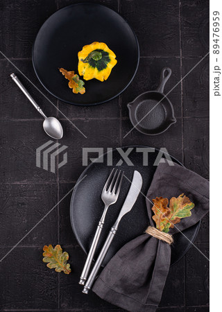 Autumn table setting on dark tile background Autumn table setting on dark tile background 89476959
