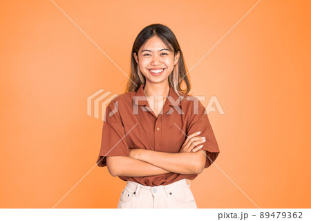 beautiful ethnic asian woman stand with crossed hands on isolated beautiful ethnic asian woman stand with crossed hands on isolated 89479362