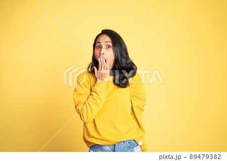 woman feeling shocked and suprised over isolated background 89479382