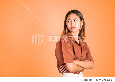 serious expression portrait of young asian woman over isolated background 89479383
