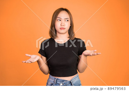 asian woman opening two palms feeling uncertain 89479563