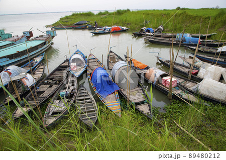 Beautiful Landscape View of Some wooden fishing boats on the green bank of the Padma river in Bangladesh 89480212