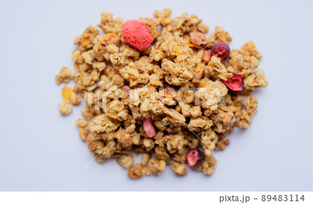 Close-up of granola, breakfast dish, snack. On the photo is a granule of oatmeal, honey and berries. 89483114
