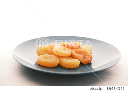 Apricot fruit half on wooden board on table  89484341