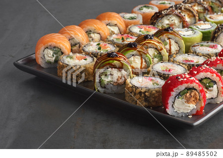 Sushi set. Roll with fresh ingredients on stone background. Sushi set. Roll with fresh ingredients on stone background. 89485502