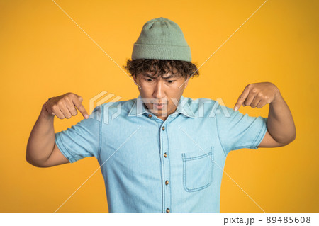 man with two fingers pointing down on isolated background man with two fingers pointing down on isolated background 89485608