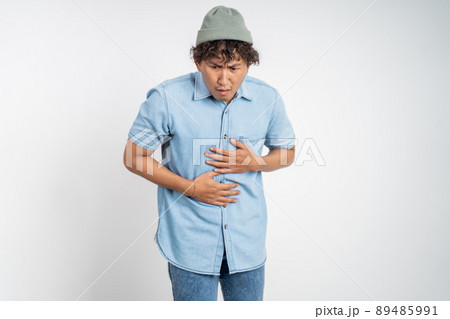 man having stomach ache on background isolated man having stomach ache on background isolated 89485991