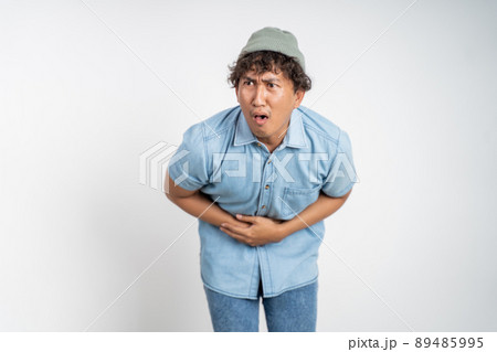 man having stomach ache on background isolated man having stomach ache on background isolated 89485995