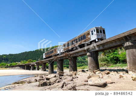 日南海岸の快晴で青空が広がる宮崎県日南市山王の隈谷川橋梁を走るJR九州日南線ローカル特急海幸山幸 89486542