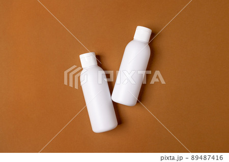 A set of empty white bottles with cosmetics on brown background . Eco-friendly cosmetics. The concept of cosmetic skin and body care, treatment, youth preservation. A set of empty white bottles with cosmetics on brown background . Eco-friendly cosmetics. The concept of cosmetic skin and body care, treatment, youth preservation. 89487416