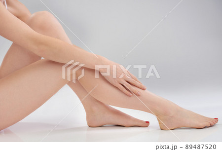 Silky smooth. Cropped image of a woman touching her smooth legs. Silky smooth. Cropped image of a woman touching her smooth legs. 89487520