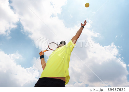 Hes king of the clay. Shot of a male tennis player about to serve. Hes king of the clay. Shot of a male tennis player about to serve. 89487622