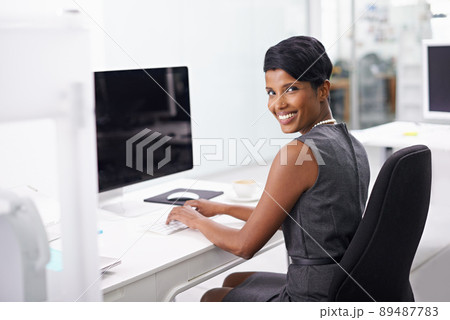 Im always on the job. Shot of an attractive young woman businesswoman in her office. Im always on the job. Shot of an attractive young woman businesswoman in her office. 89487783