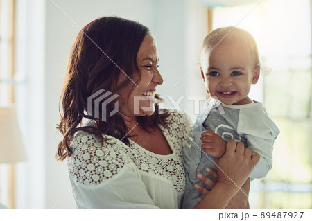 All of me belongs to you. Shot of a mother and her adorable son smiling together at home. 89487927