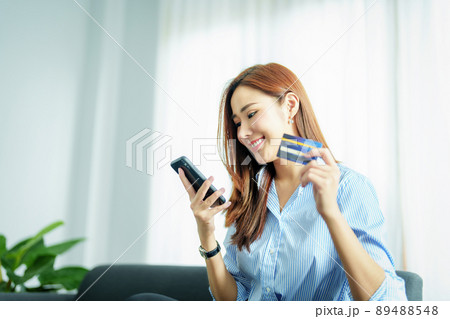 Online Shopping and Internet Payments, Portrait of Asian woman are using their mobile phones and credit cards to shop online or conduct errands in the digital world Online Shopping and Internet Payments, Portrait of Asian woman are using their mobile phones and credit cards to shop online or conduct errands in the digital world 89488548