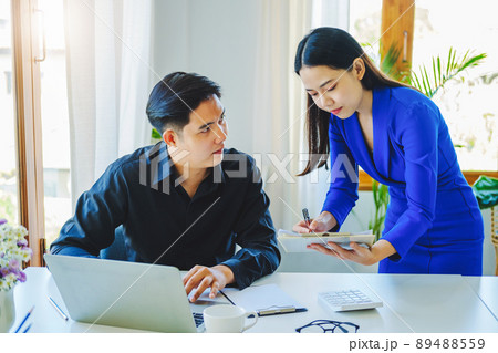 negotiation, analysis, discussion,asian female economist pointing out a document explaining the investment finance program to the company owner to plan marketing and hedging business risks negotiation, analysis, discussion,asian female economist pointing out a document explaining the investment finance program to the company owner to plan marketing and hedging business risks 89488559