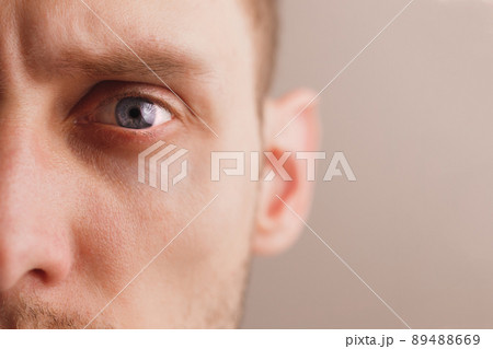 Young worried man with stern look. Close-up portrait half face 89488669