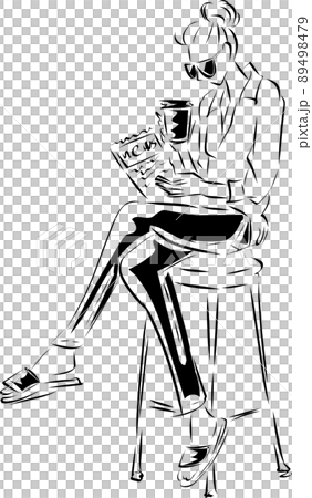 A woman reading a newspaper while drinking coffee at a cafe 89498479