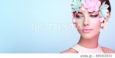 Face of beautiful woman decorated with flowers Face of beautiful woman decorated with flowers 89503935