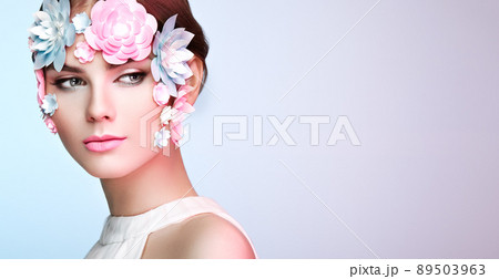 Face of beautiful woman decorated with flowers Face of beautiful woman decorated with flowers 89503963