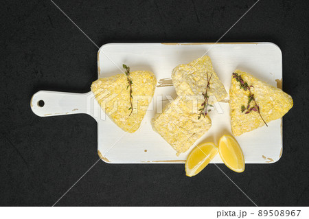 Overhead view of semifinished frozen fish cutlet in breading Overhead view of semifinished frozen fish cutlet in breading 89508967