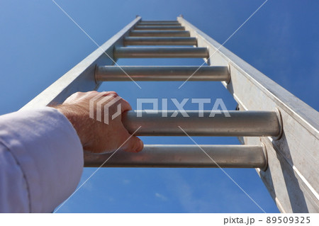 Hands climbing a ladder to the sky 89509325