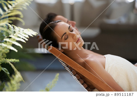 Peace and calm in luxury. Cropped shot of a mature couple relaxing side by side on lounge chairs outside. Peace and calm in luxury. Cropped shot of a mature couple relaxing side by side on lounge chairs outside. 89511187