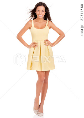 Ready to show summer a good time. Full-length studio portrait of a beautiful young woman posing in a yellow dress. Ready to show summer a good time. Full-length studio portrait of a beautiful young woman posing in a yellow dress. 89511580