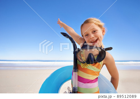 Lets get in there. Portrait of a cute little girl standing on the beach with her snorkeling gear and swimming tube. Lets get in there. Portrait of a cute little girl standing on the beach with her snorkeling gear and swimming tube. 89512089