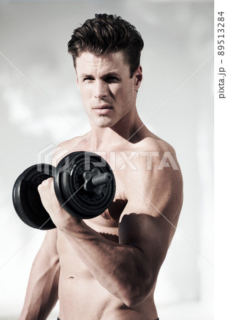 To get a body this good you have to work out. A masculine male with no shirt on holding weights. To get a body this good you have to work out. A masculine male with no shirt on holding weights. 89513284